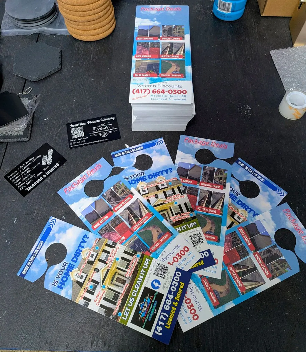 A stack of door hangers for a pressure-washing company fanned out on a counter